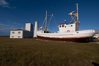 The new Garðskagaviti lighthouse and a boat that has been restored and is open to the public.