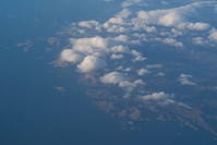islands and clouds (and a couple of tiny icebergs) off the tip of southern Greenland